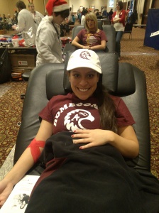 Lia Capaldini, Augsburg College senior, donating blood for the first time at the 12 Hours of Giving on Decbember 23, 2013.